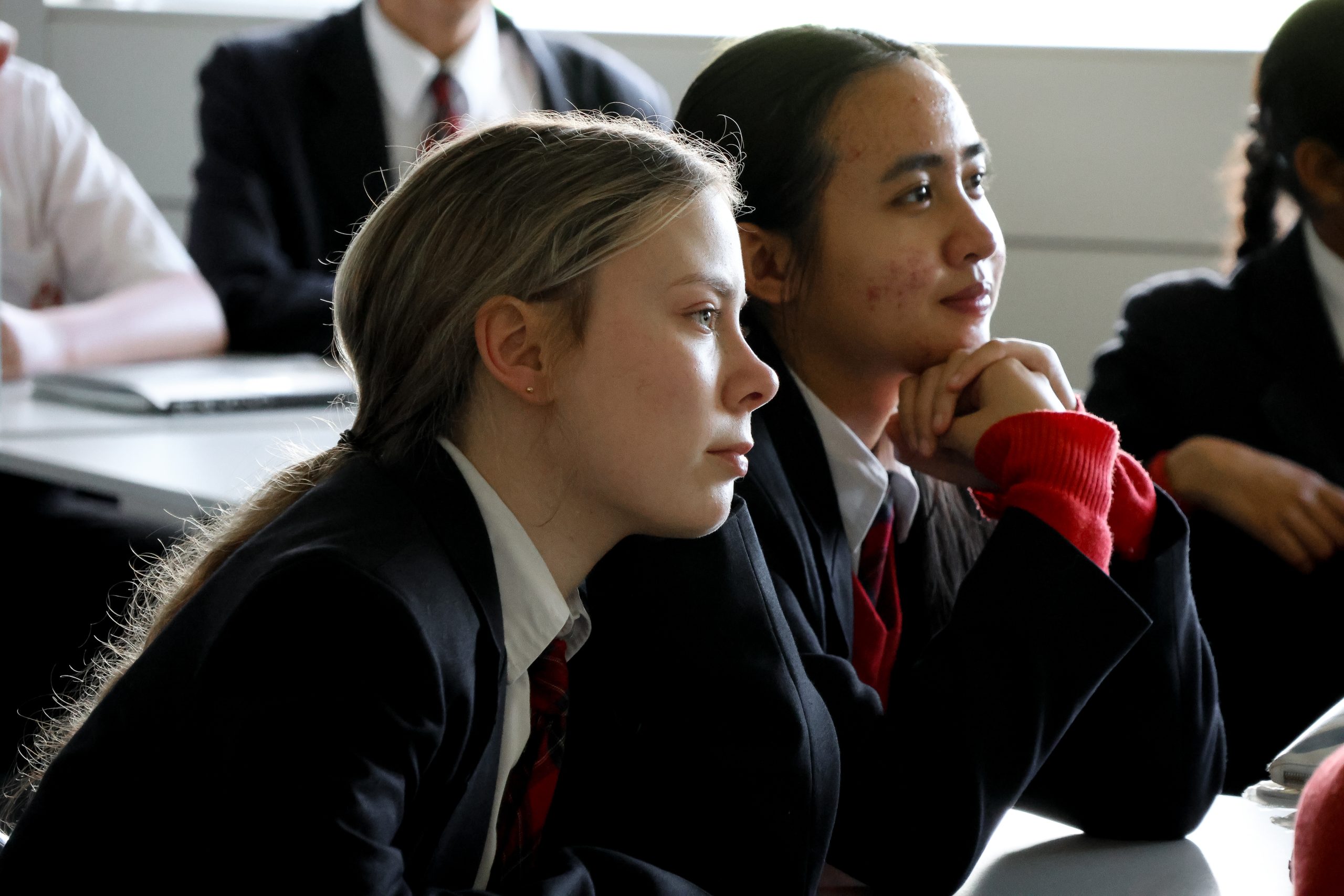 a group of girls sitting in a classroom