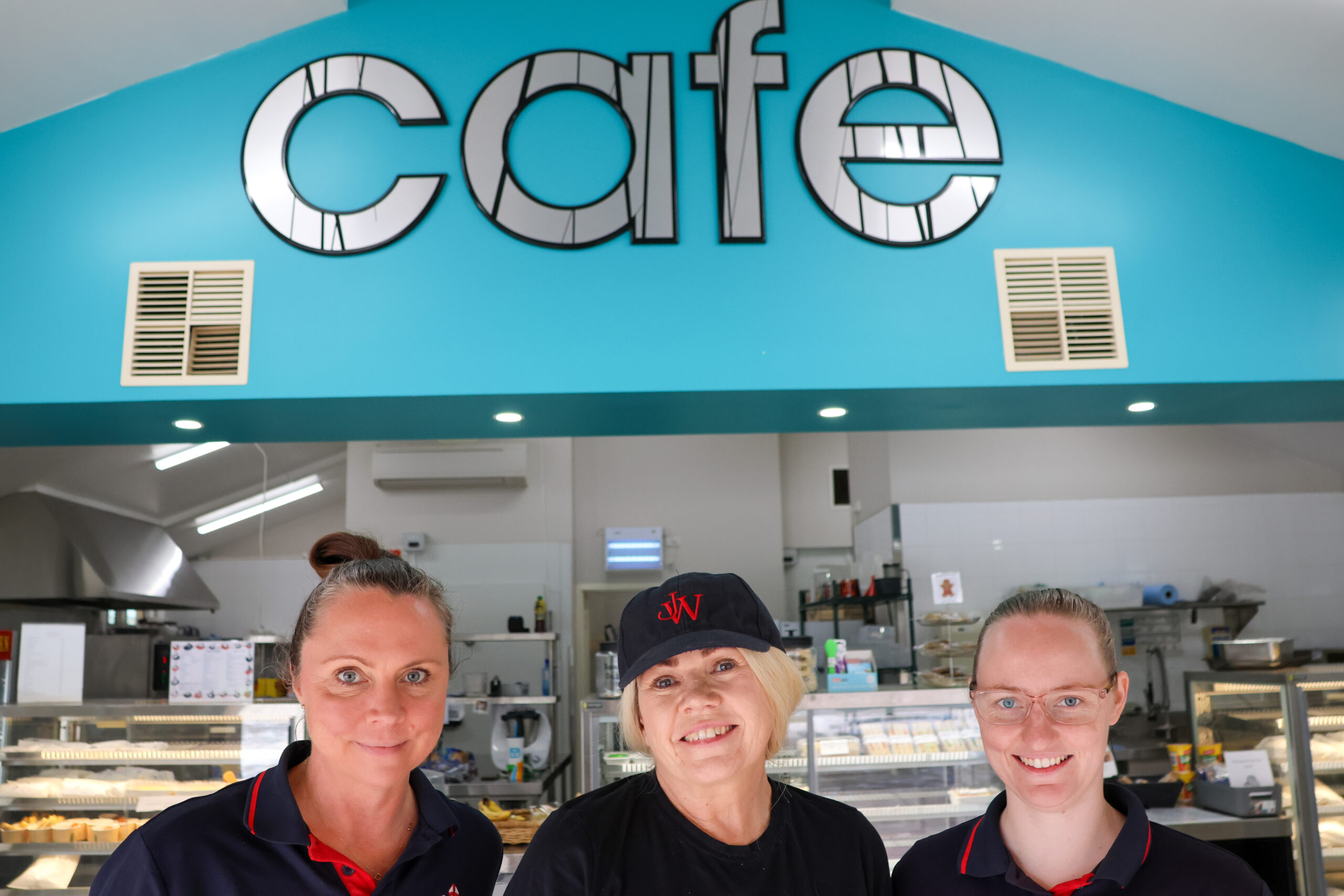 Sky Shelley and Jamie Lee with cafe sign scaled Café 10